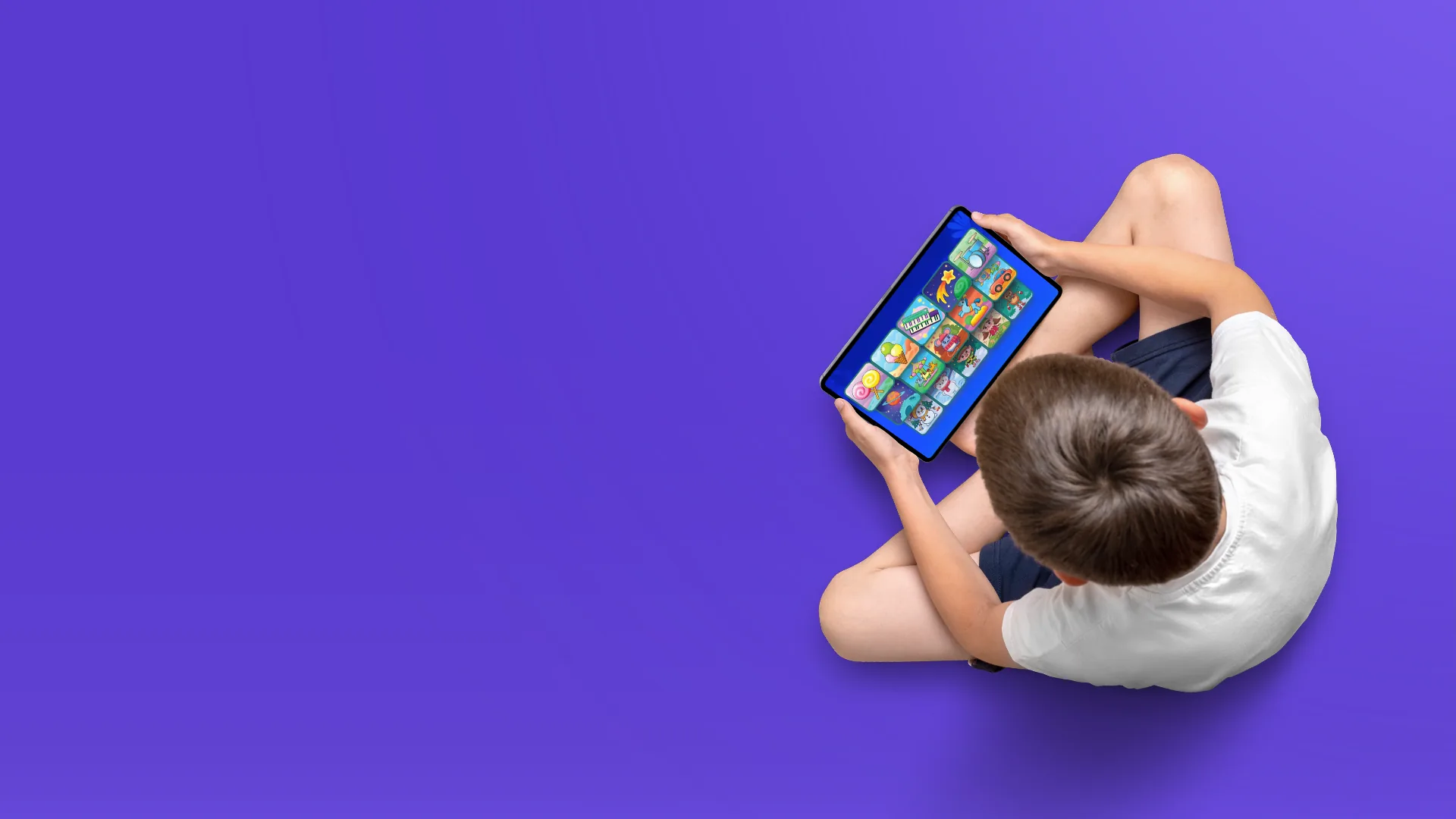 Child playing educational mobile game on tablet, learning through interactive gameplay