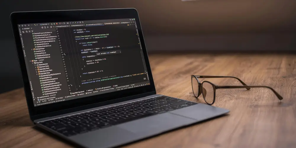 Developer reviewing code during game outsourcing evaluation